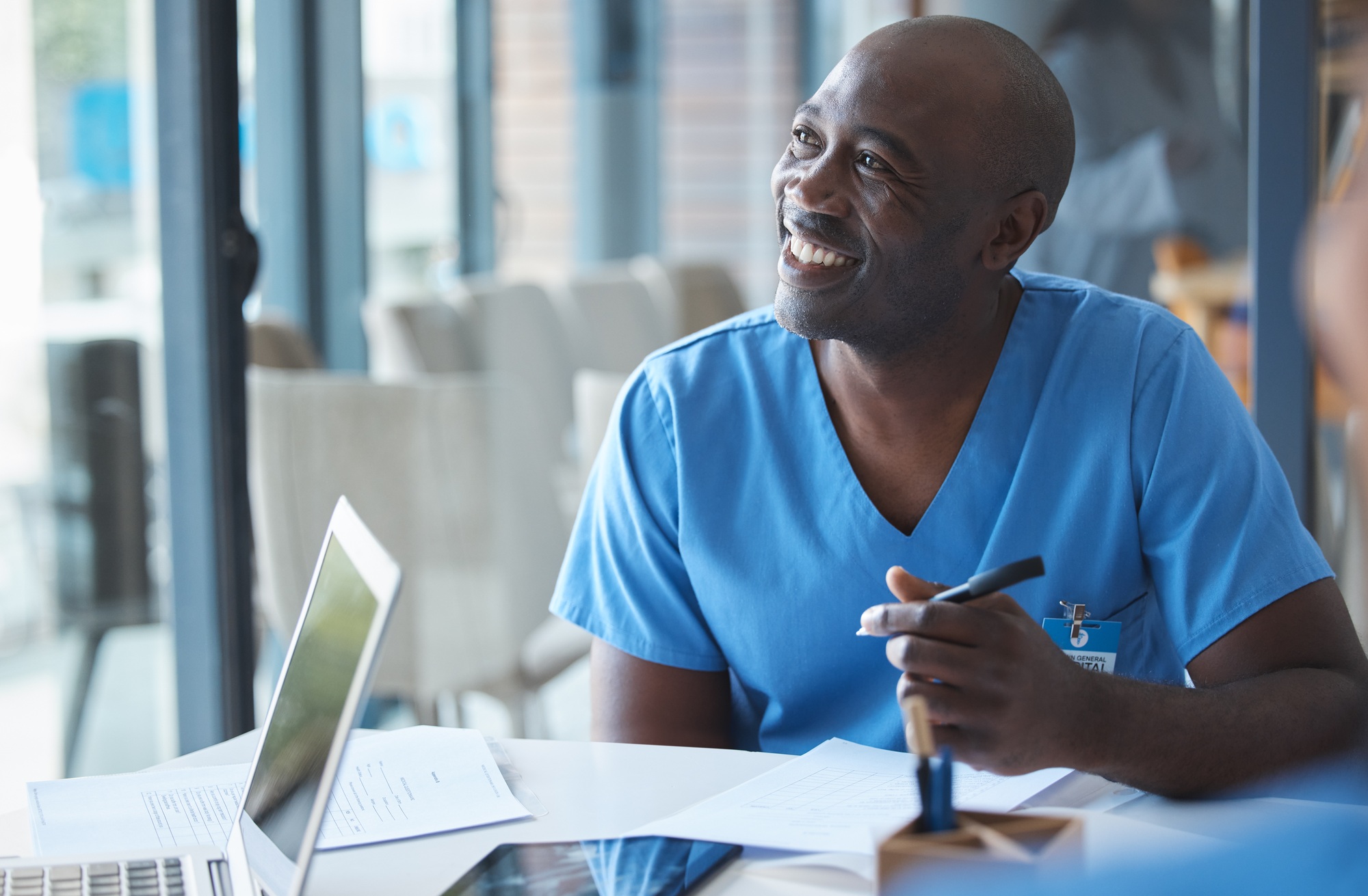 Cropped shot of a handsome young male nurse sitting in the hospital boardroom during a meeting